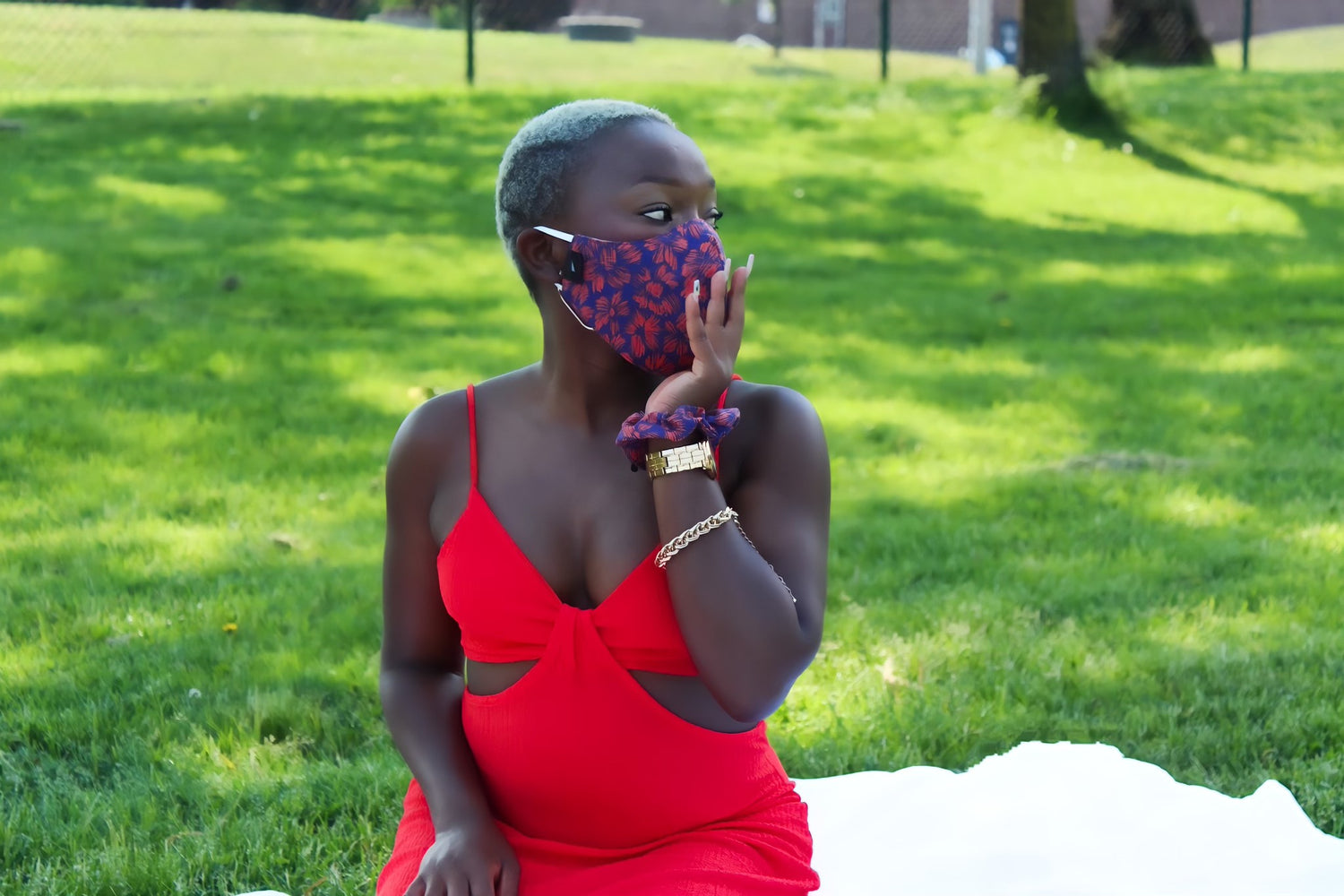 woman in red dress wearing purple mask and scrunchie